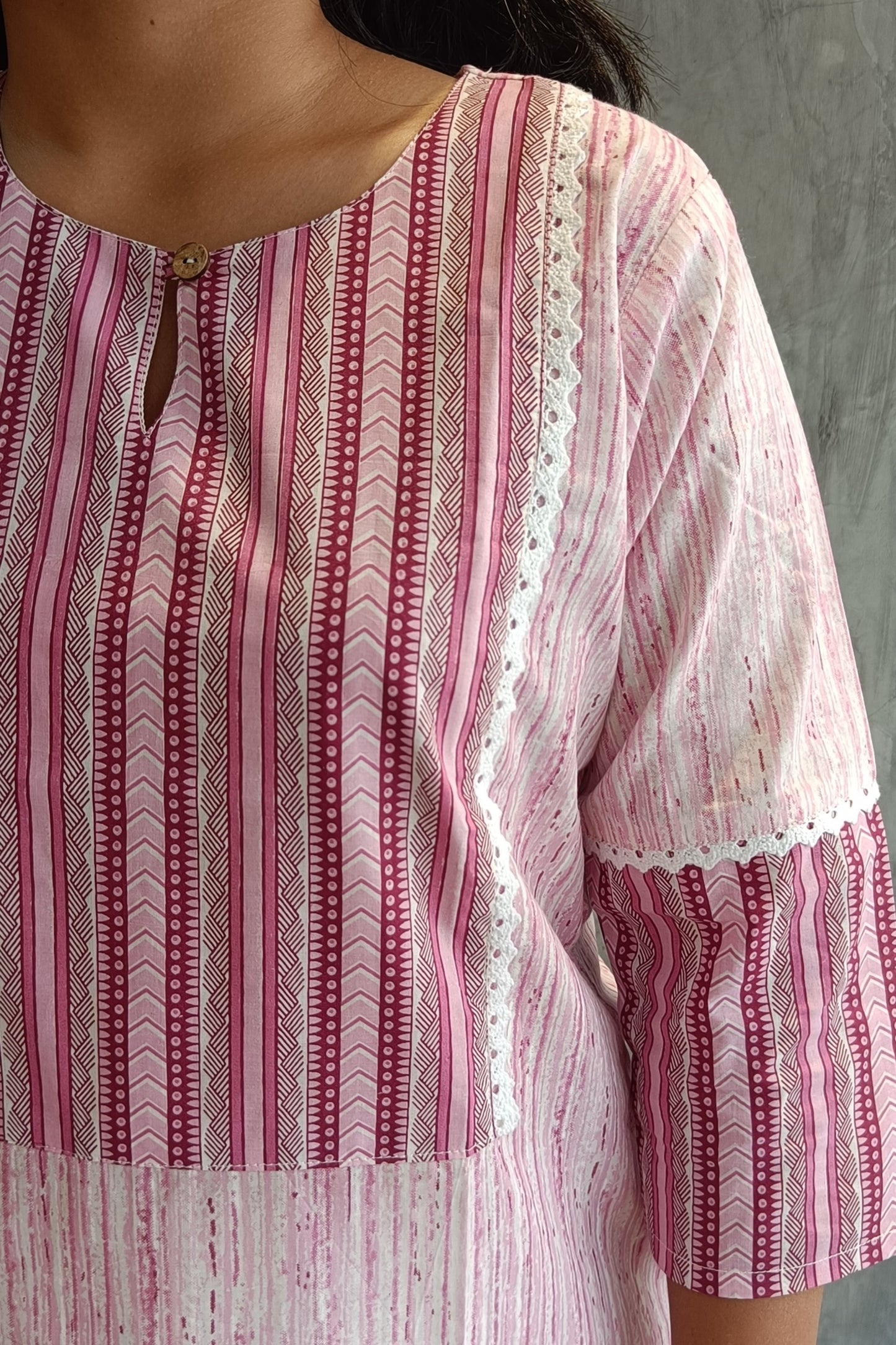 "Close-up of Loomkar soft pink handloom cotton kurti with artisan floral screen print, perfect for office and casual wear."