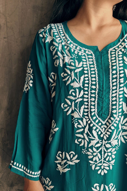 Close - up of floral Chikankari embroidery on teal blue modal silk kurta 
