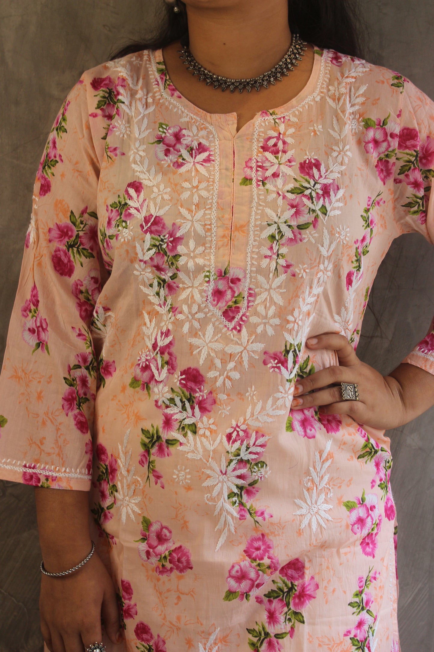 Close-up of intricate floral Chikankari embroidery on peach Malmal cotton kurti - Loomkar handmade detail