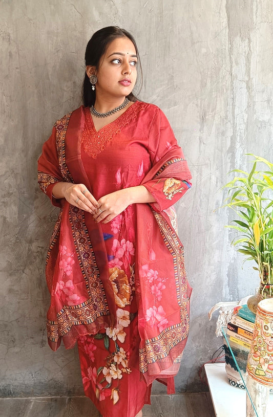 Model wearing rust red cotton silk straight kurti set with matching pants and floral dupatta 