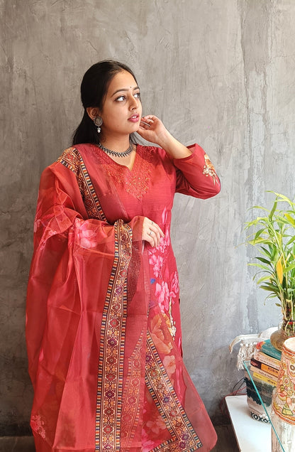 full view of rust red cotton silk kurti styled with floral dupatta