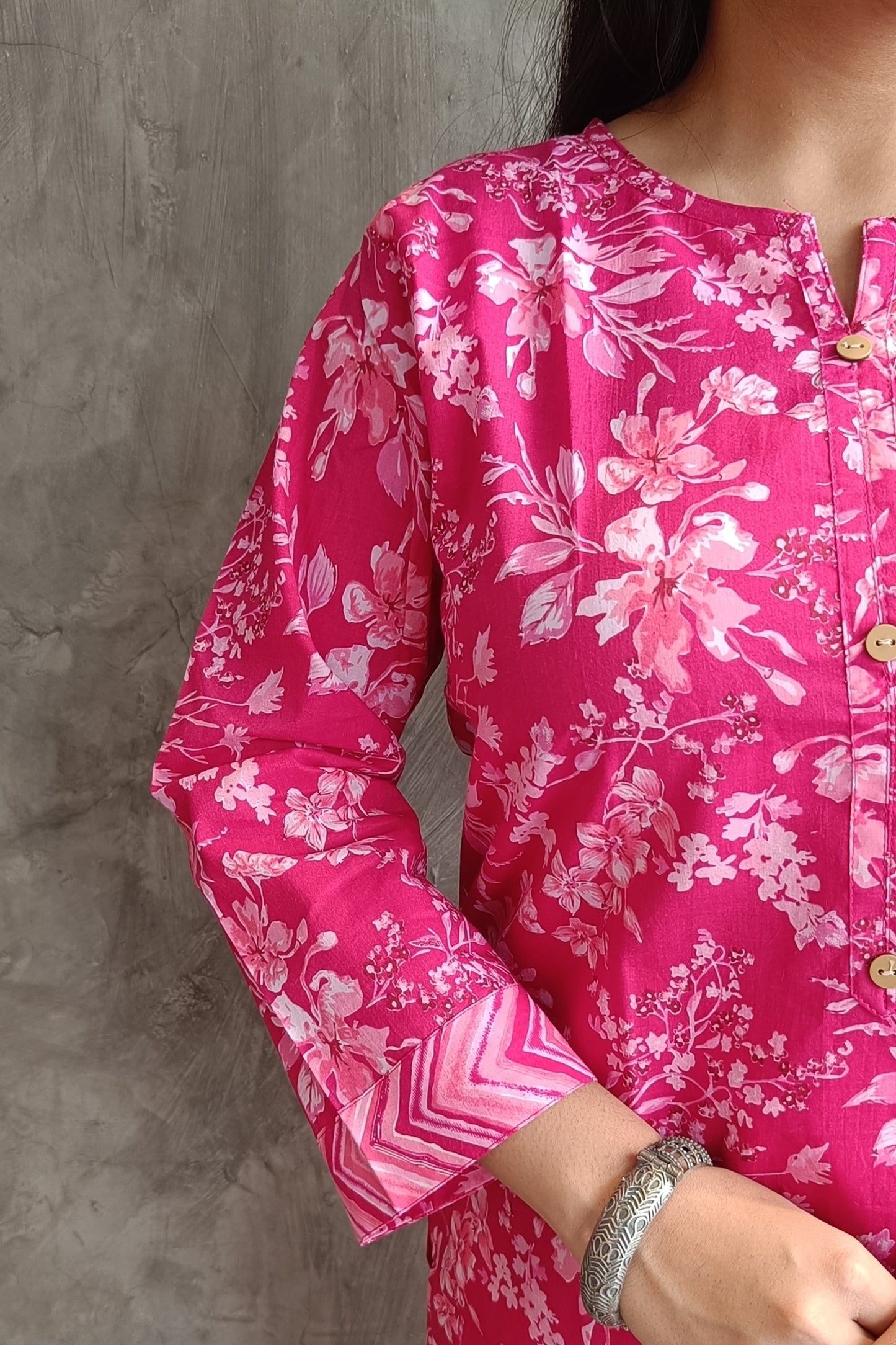 "Detail shot of hand screen-printed floral motifs on Loomkar bright pink co-ord set kurti and pants."
