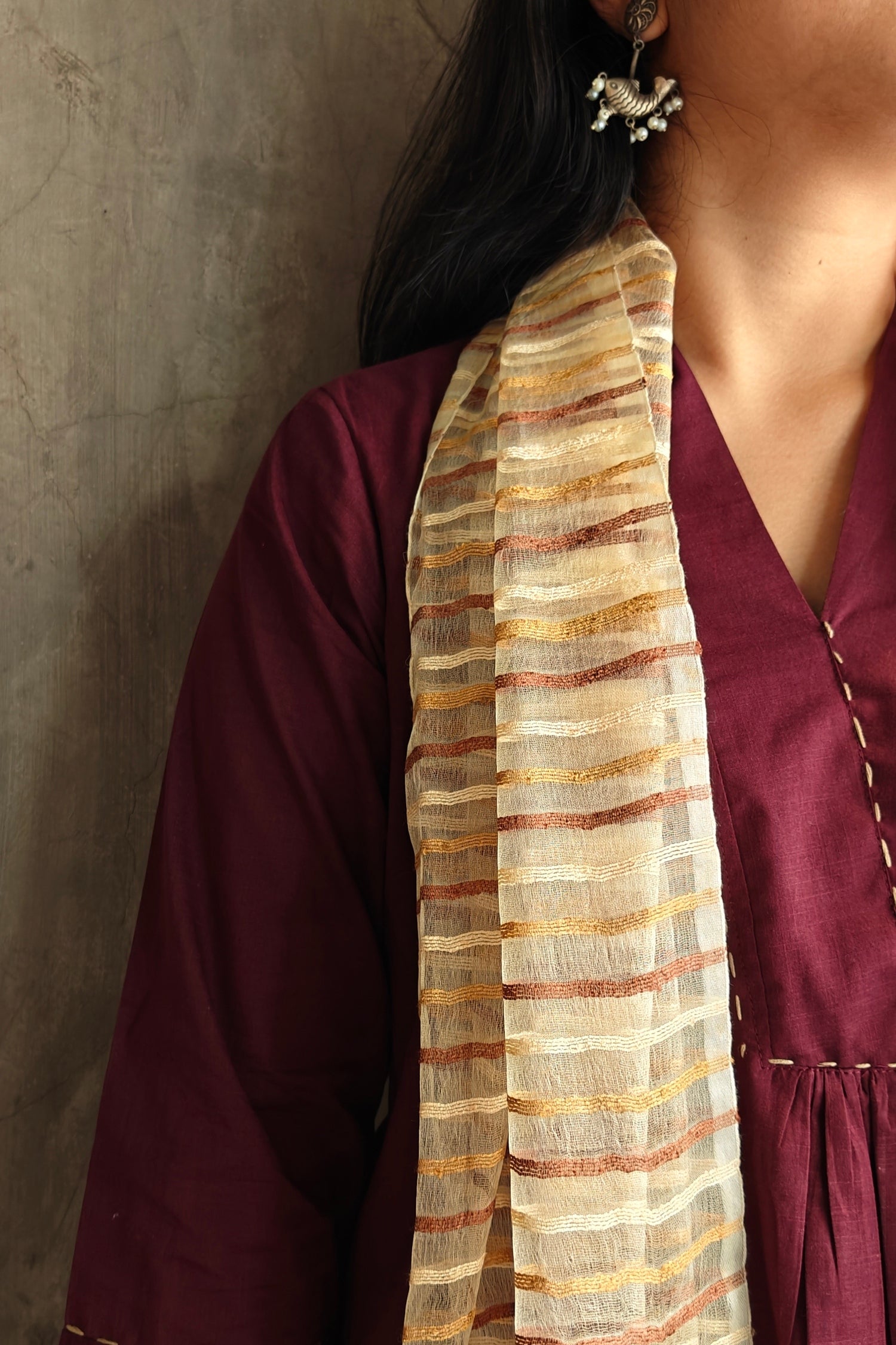 Close-up of Dupatta draped elegantly over shoulder with fine handwoven patterns.