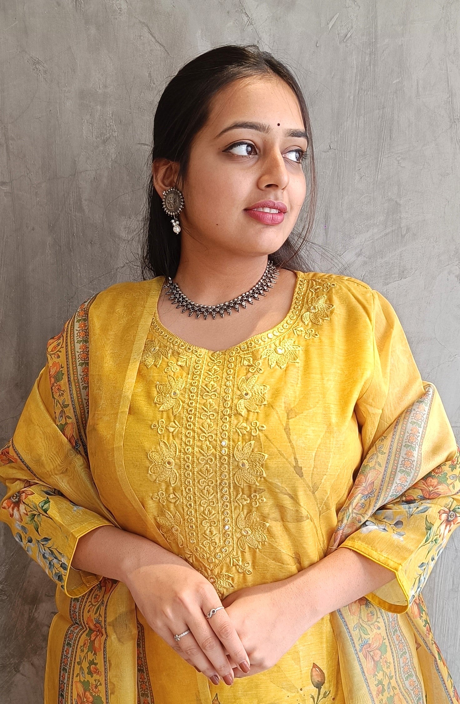 model wearing yellow kurti set with floral dupatta and straight-fit pants