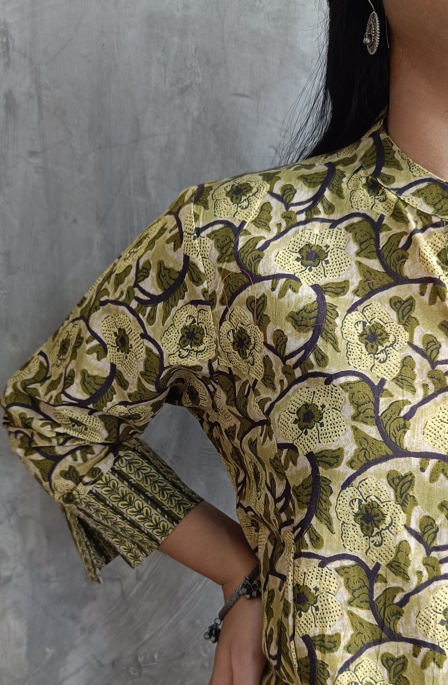 "Detail shot of hand screen-printed floral motifs on Loomkar green co-ord set kurti and pants."