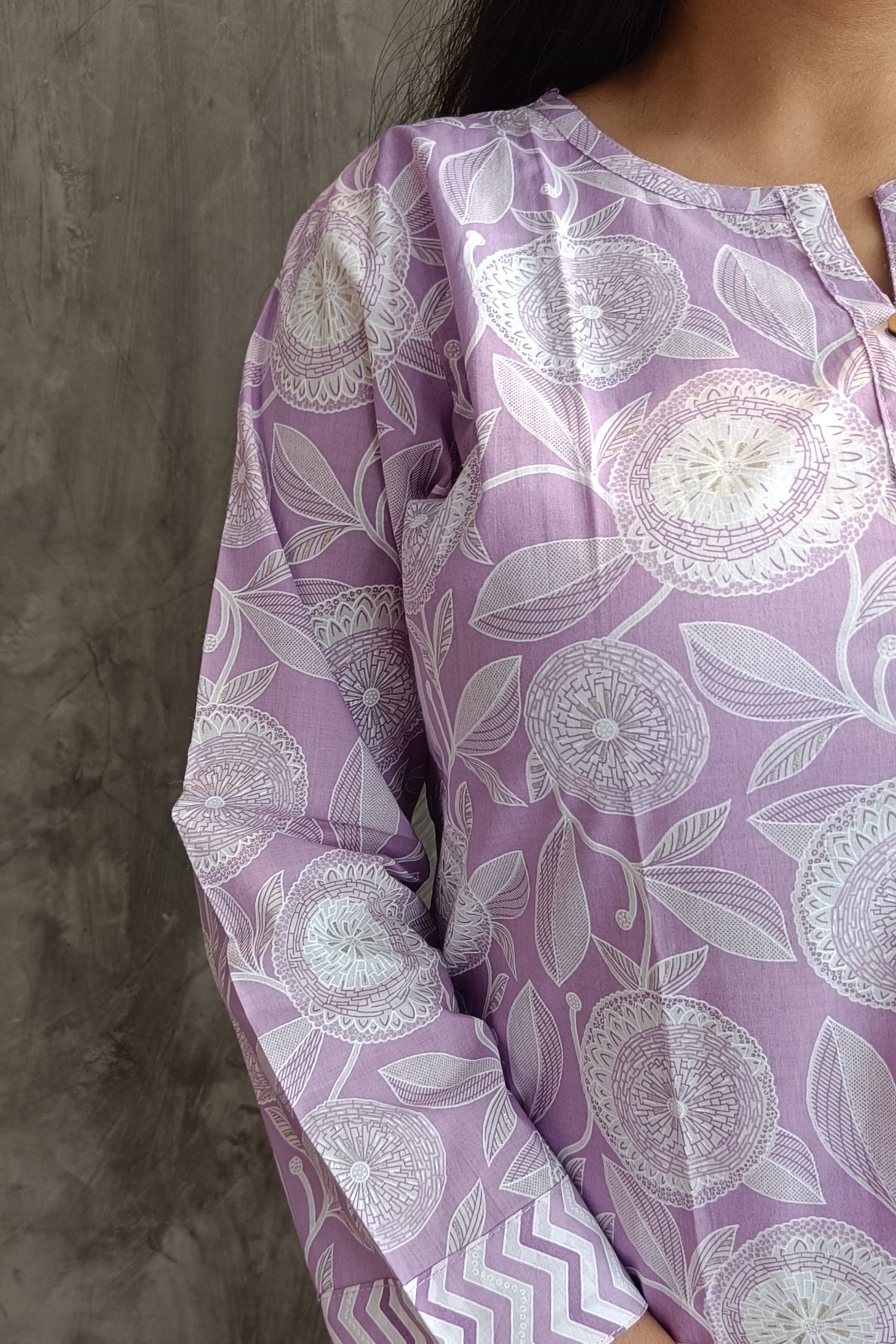 "Detail shot of hand screen-printed floral motifs on Loomkar lavender white co-ord set kurti and pants"