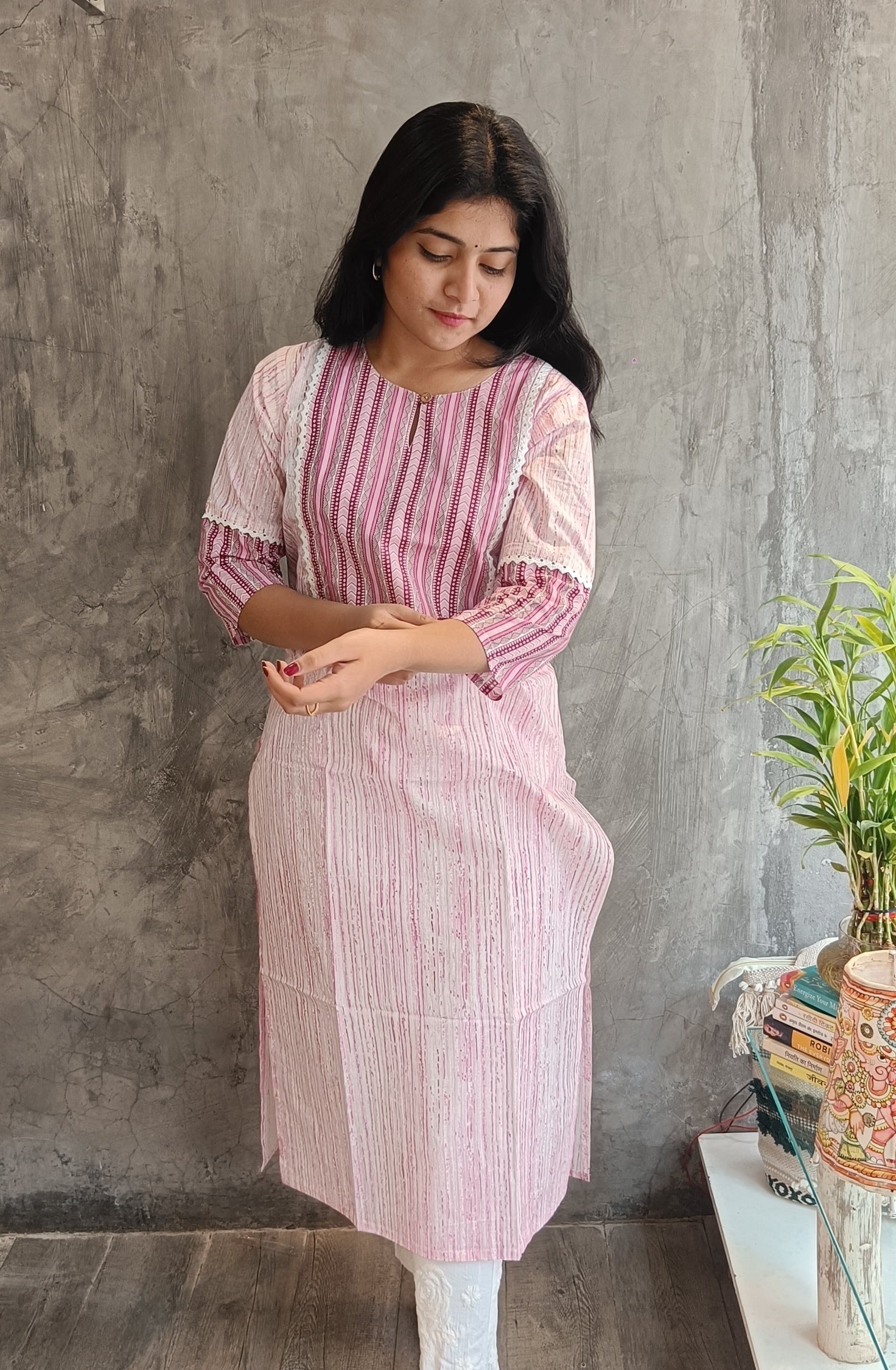 "Front view of Loomkar's soft pink floral handloom cotton kurti in Raipur, showing the elegant straight-fit ethnic design."