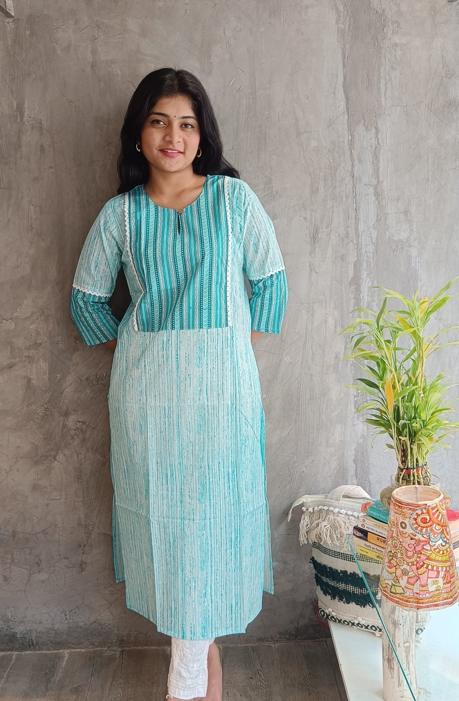 Model in Loomkar's tail green handloom cotton kurti with floral screen print, prefect for office and casual wear."