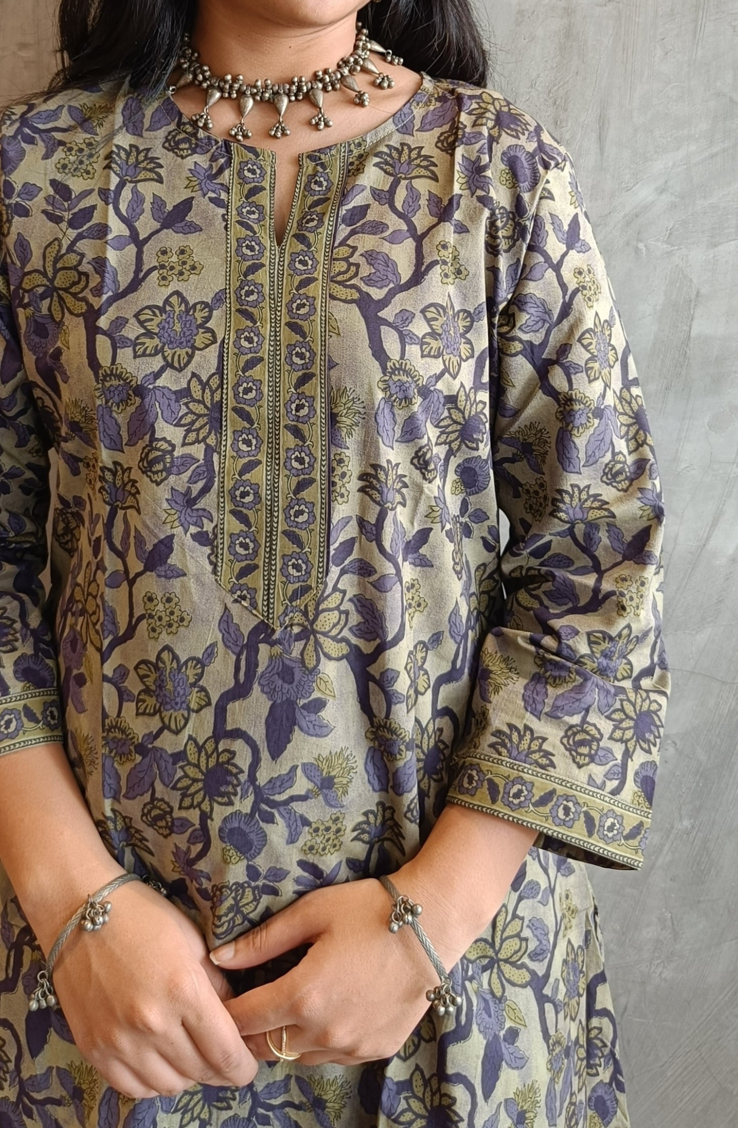 "Detail shot of floral screen print on Loomkar's purple green Vanaspati handloom cotton co-ord set in Raipur."