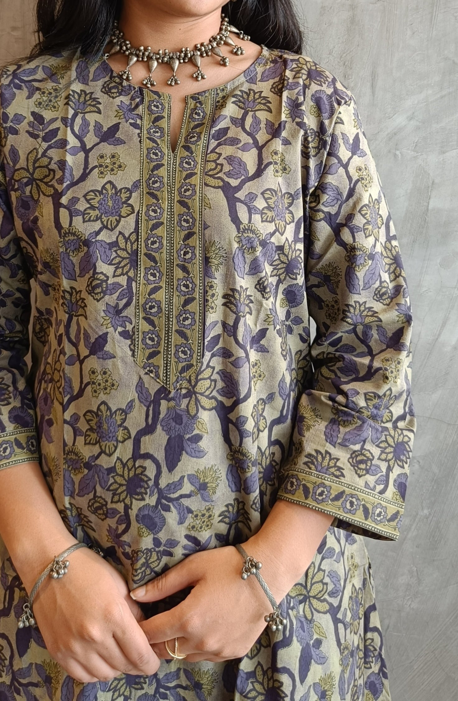 "Detail shot of floral screen print on Loomkar's purple green Vanaspati handloom cotton co-ord set in Raipur."