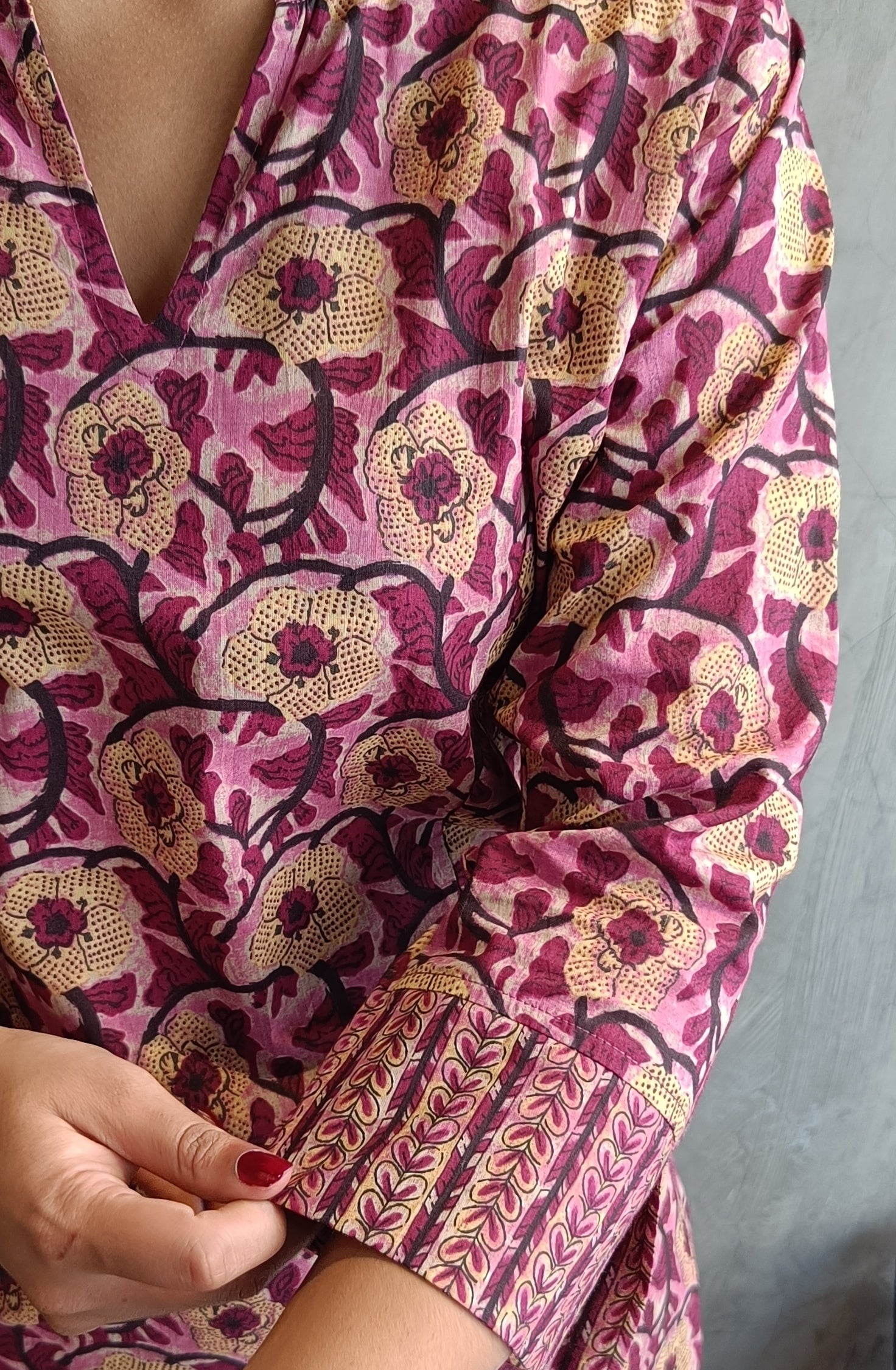 "Close-up of hand screen printed wine-pink floral motifs on cotton kurti and pant set from Loomkar."