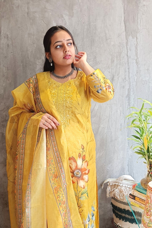 close-up of yellow cotton silk kurti with detailed embroidery and floral dupatta